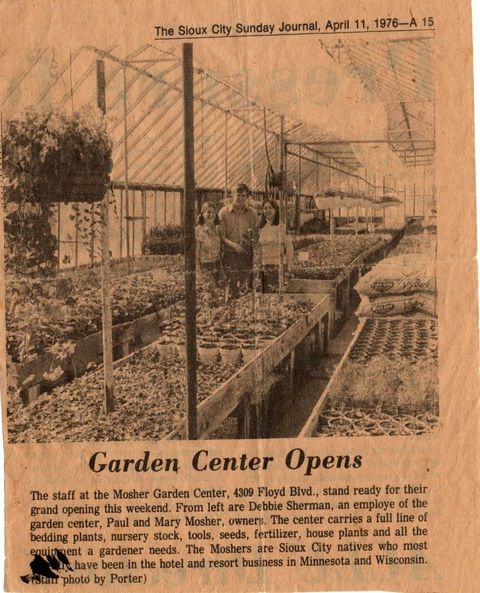Newspaper clipping of a garden center under construction, with headline “Garden Center Opens” and a photo of greenhouses.