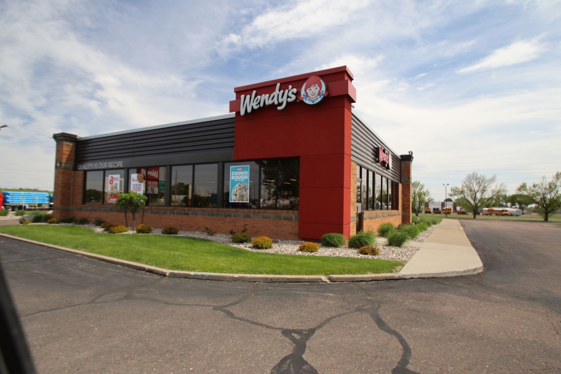 Wendy’s fast-food restaurant exterior with red signage, drive-thru, and parking lot