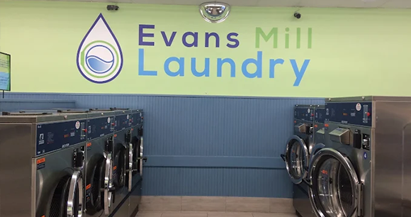 Clean washing machines at a laundromat with electronic payment options.