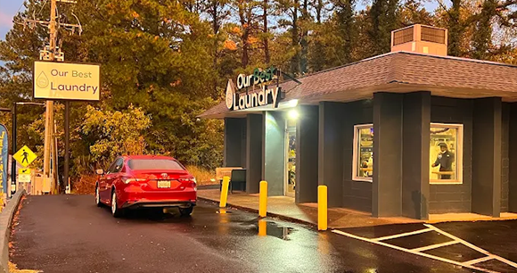 The exterior of a building offering pick up laundry service.