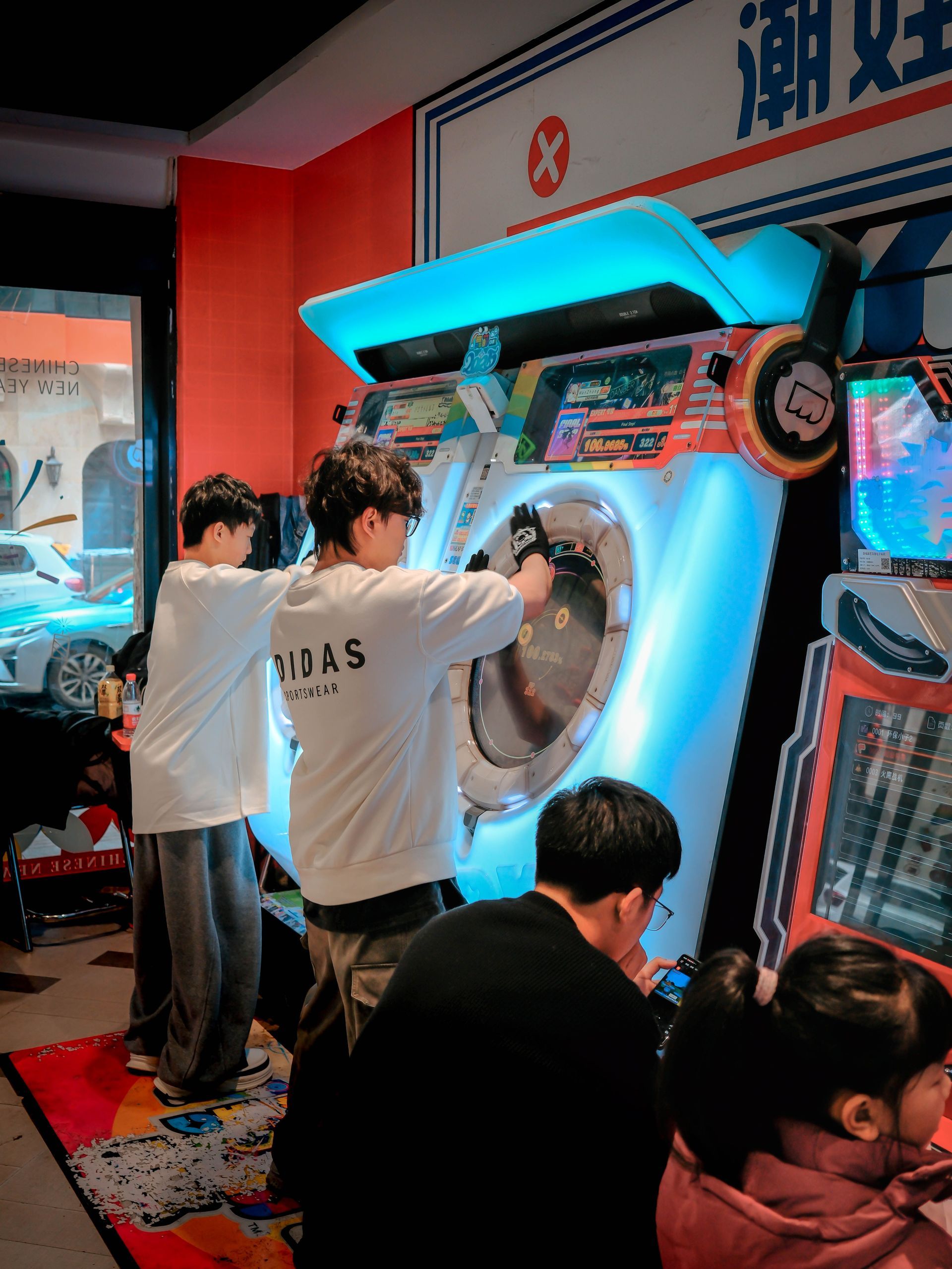 Customers play skill game machines while waiting for laundry cycles.