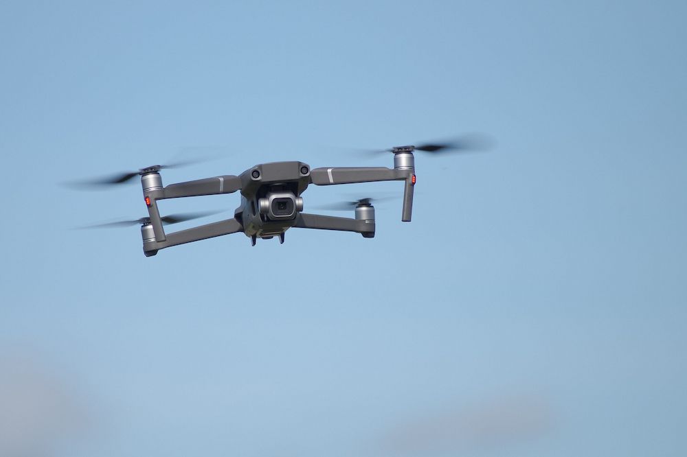 A Drone is Flying Through a Clear Blue Sky — Frontier Connect in Newtown, QLD