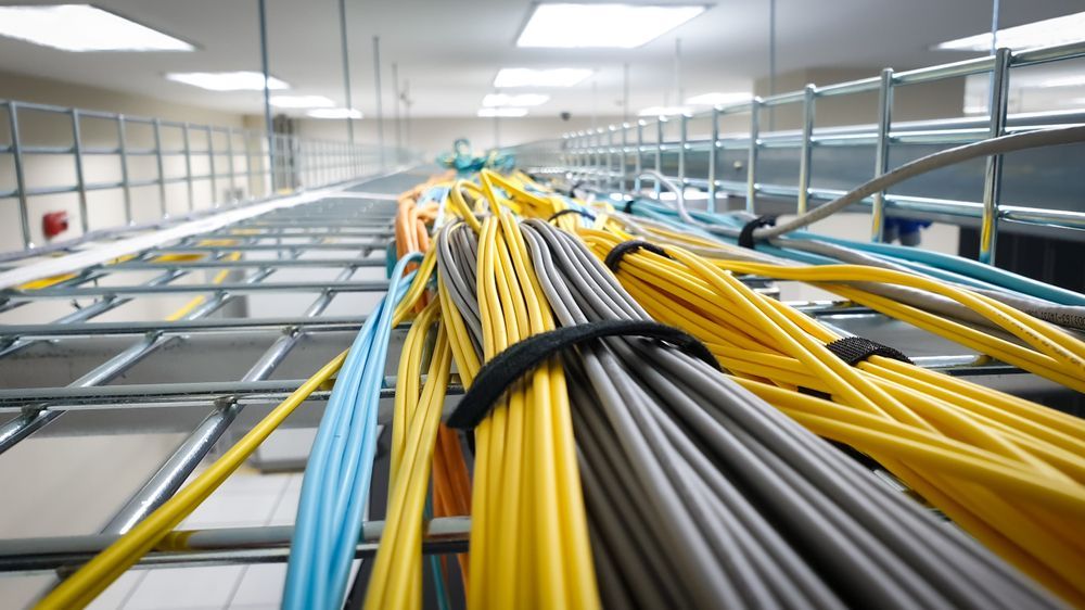 A Bunch of Wires Are Hanging From the Ceiling in a Room — Frontier Connect in Roma, QLD