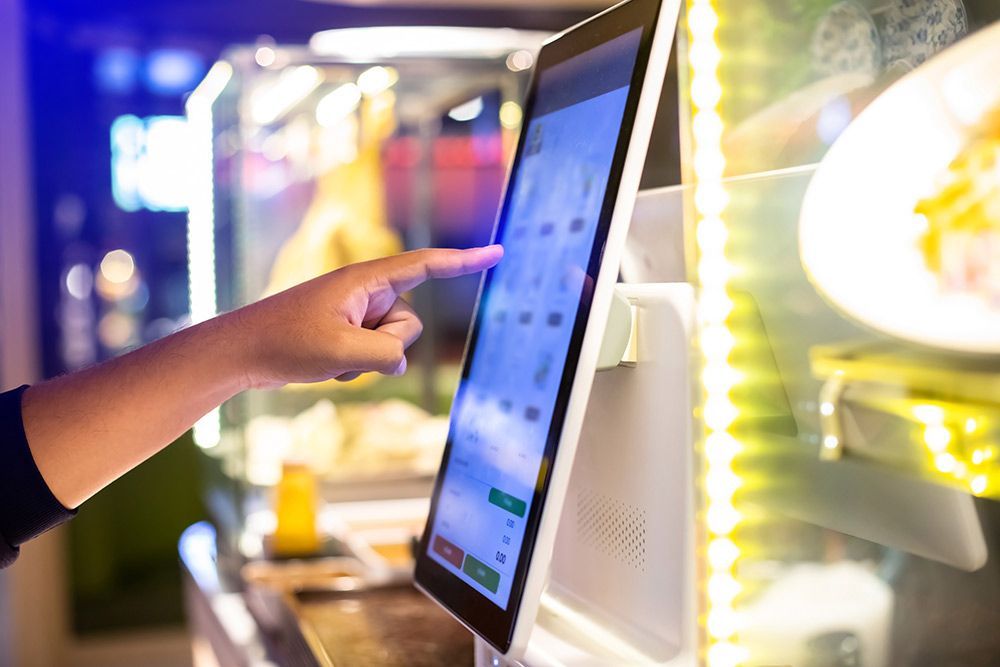 A Person is Pointing at a Tablet Screen in a Restaurant — Frontier Connect in Warwick, QLD