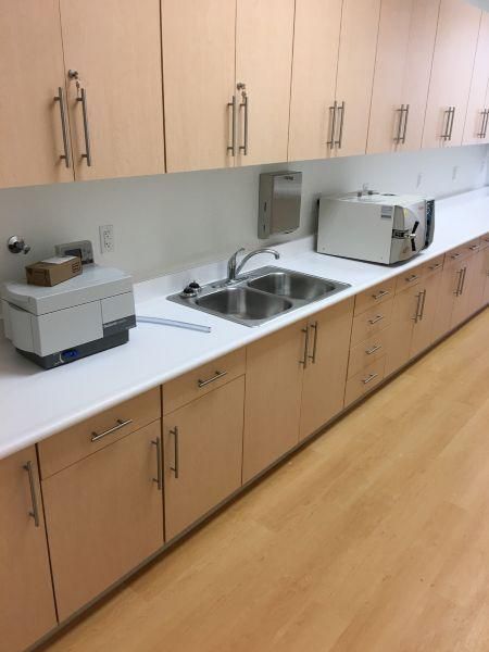 Accessible kitchenette with cabinets, sink, toaster, microwave, and countertop appliances