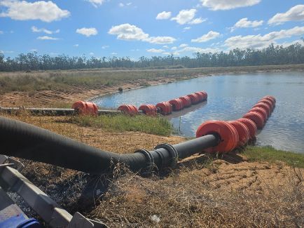 Black Hose With Orange Floats on Water — Forcequip Hire In Glanmire, QLD
