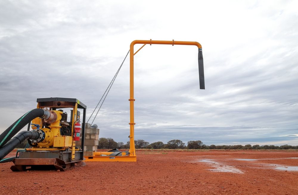 Two Workers Inspecting Red and White Pipes — Forcequip In Glanmire, QLD