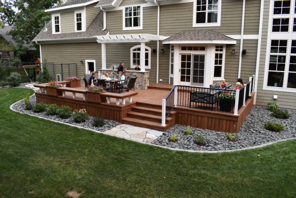 A large house with a large deck in front of it.