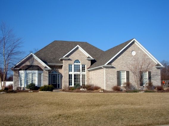 A large brick house with a gray roof