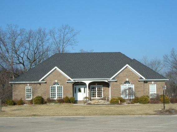 A large brick house with a black roof