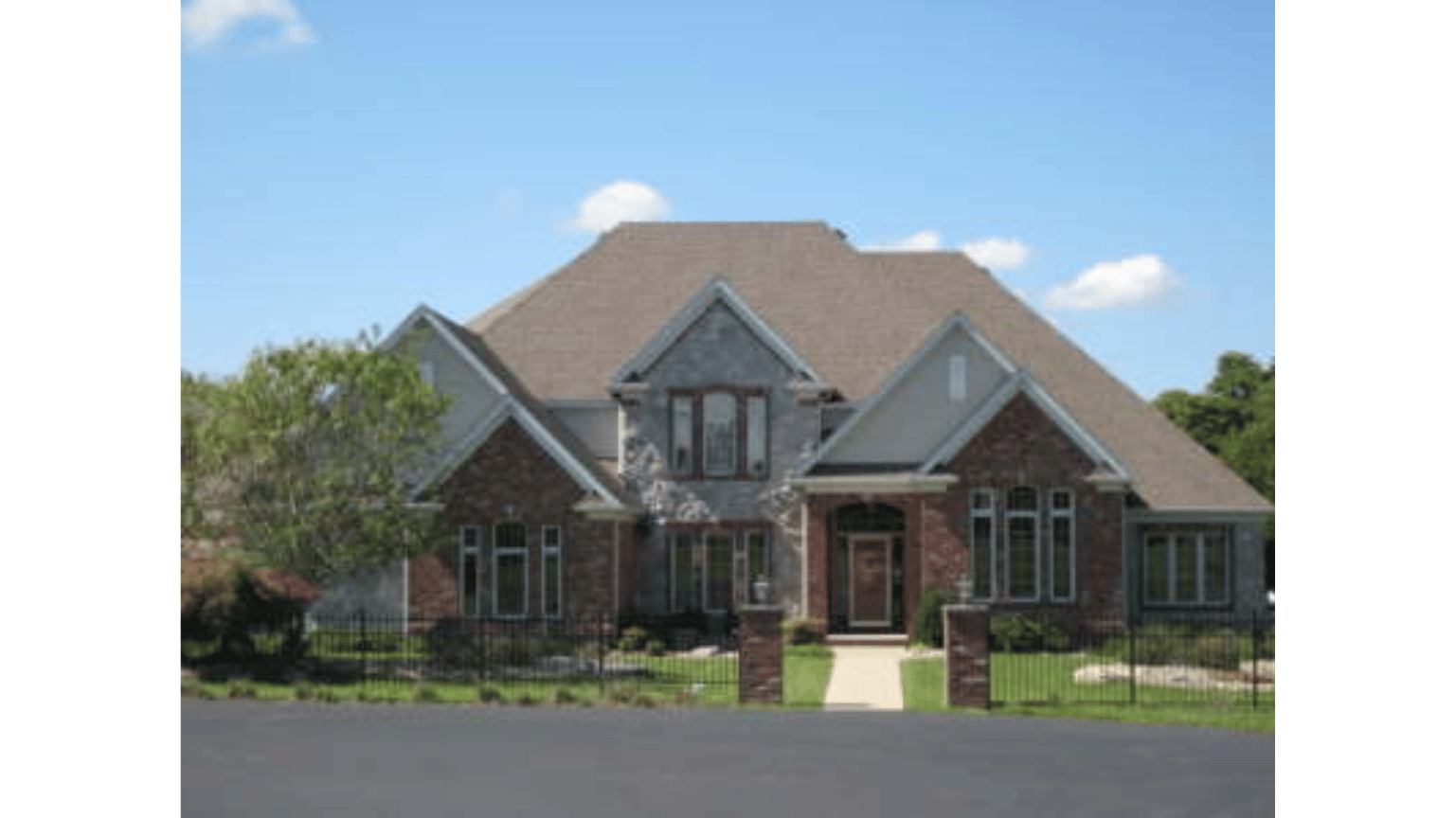 A large brick house with a brown roof