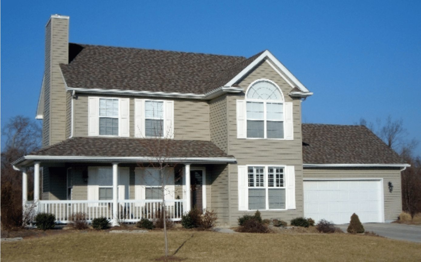 A large house with a porch and a garage