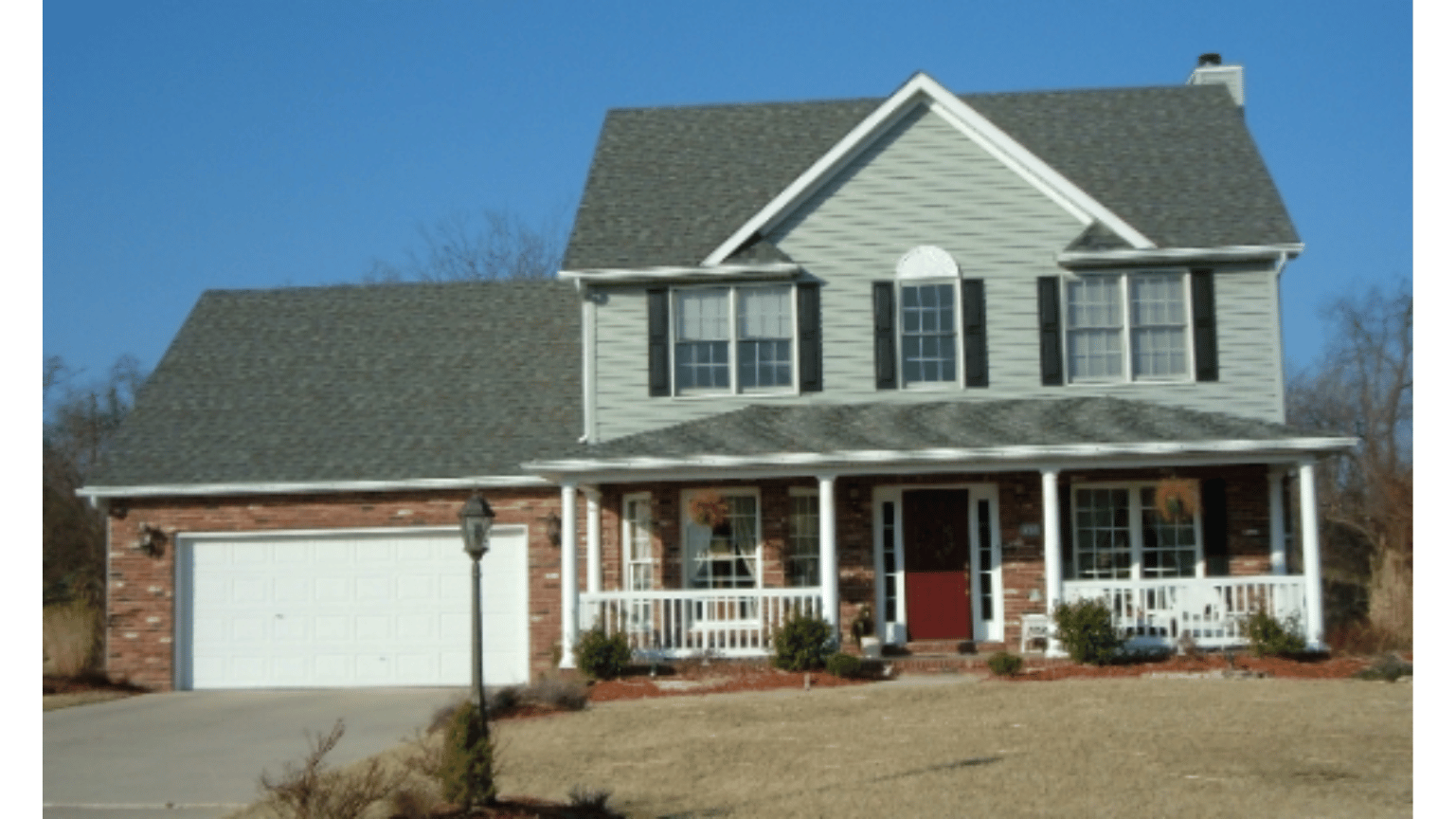 A large house with a porch and a garage
