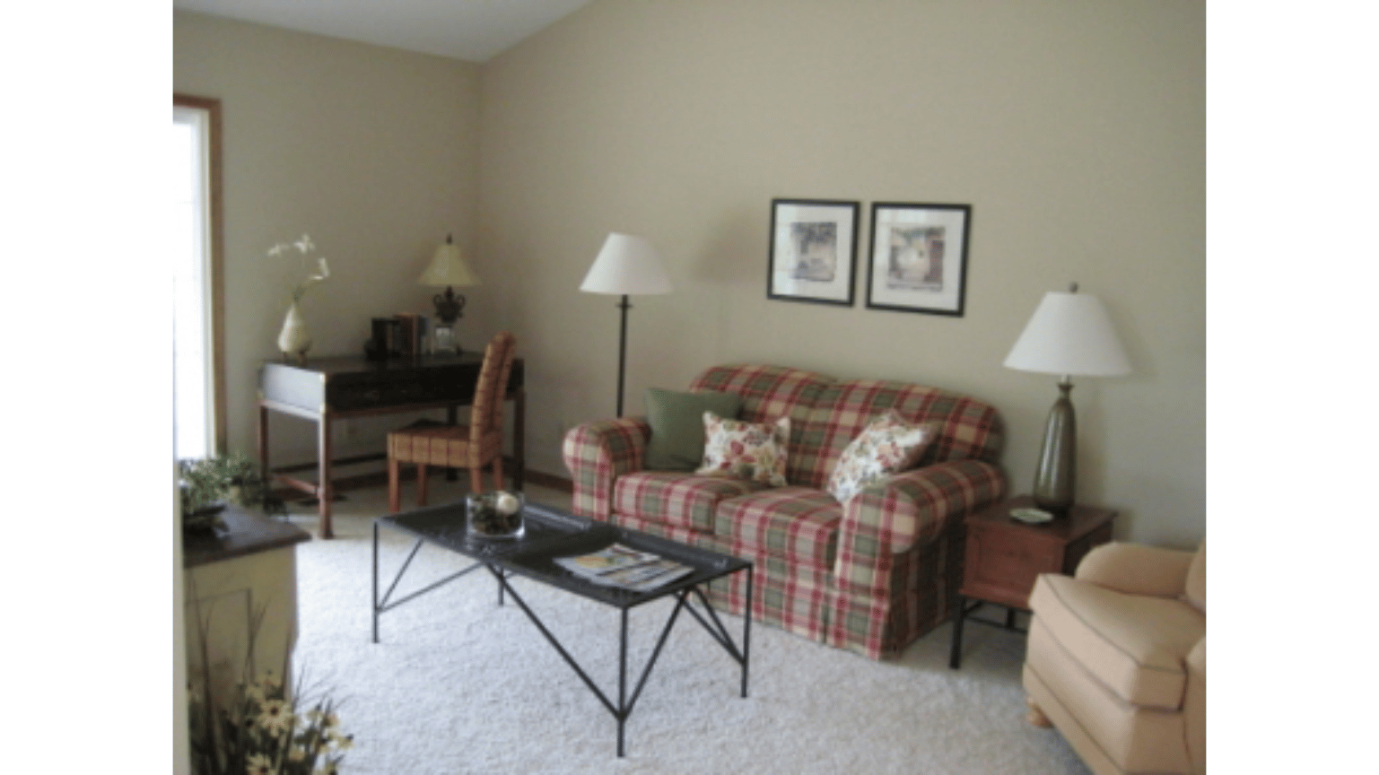 A living room with a couch and a desk