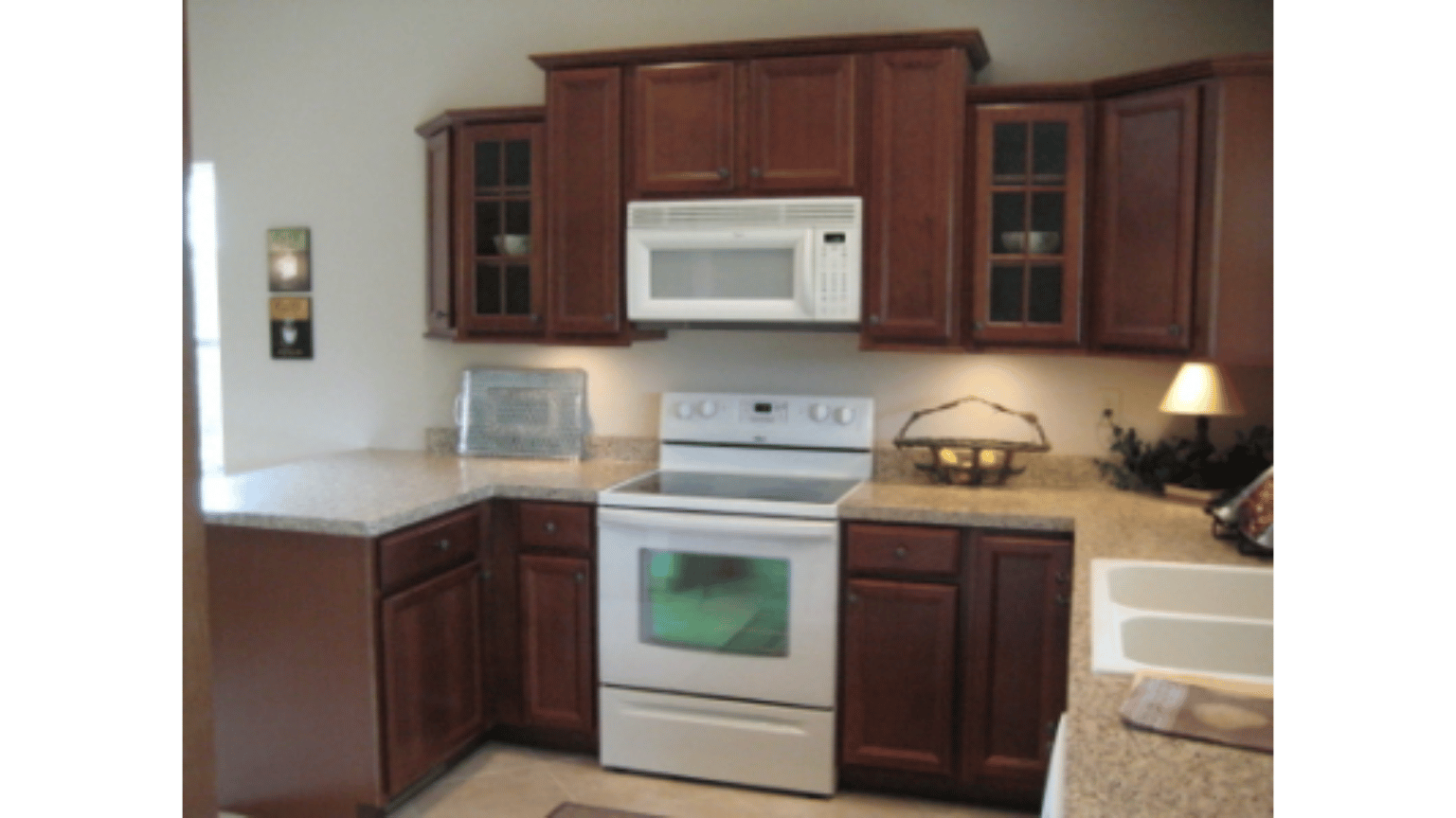 A kitchen with brown cabinets and a white stove