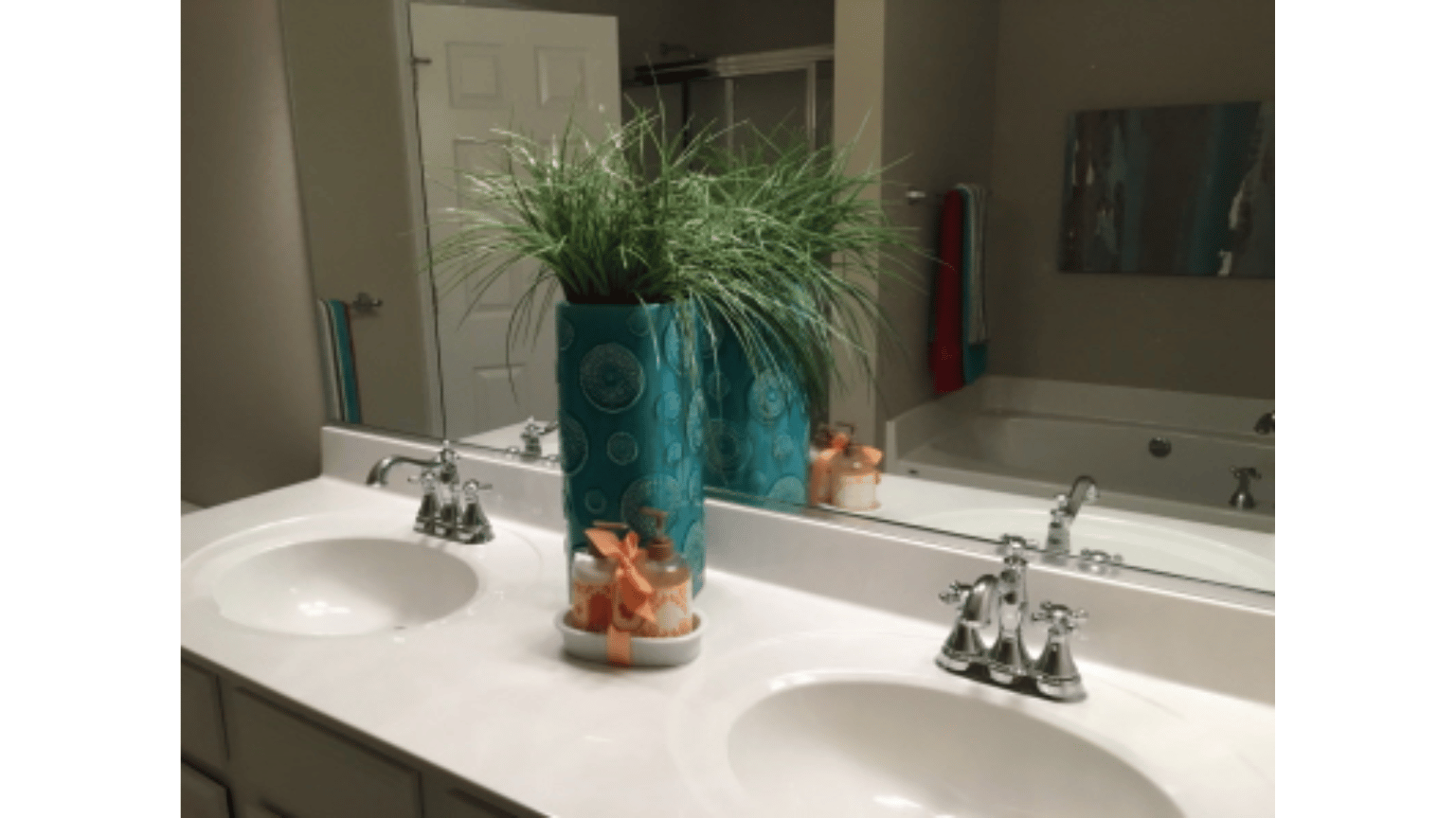 A bathroom with two sinks and a large mirror.
