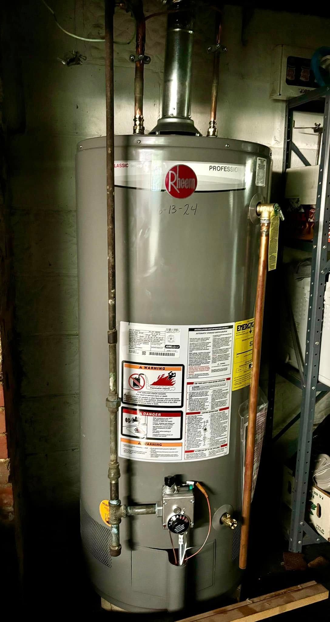 A Rheem gas water heater stands in a basement with connected copper pipes and a metal exhaust vent.