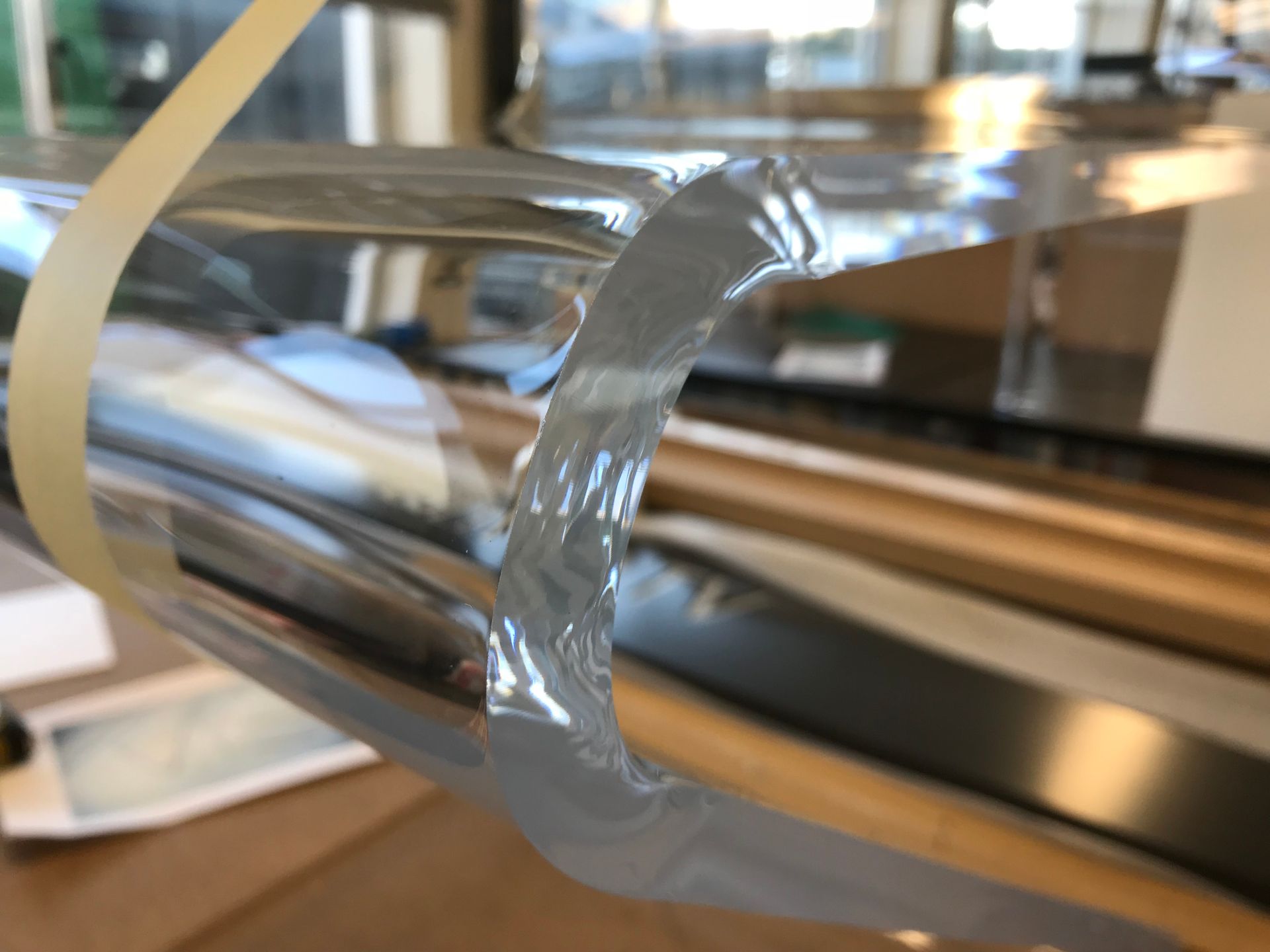Another view of tight curves to heat formed from chair in clear acrylic close up of polished edges