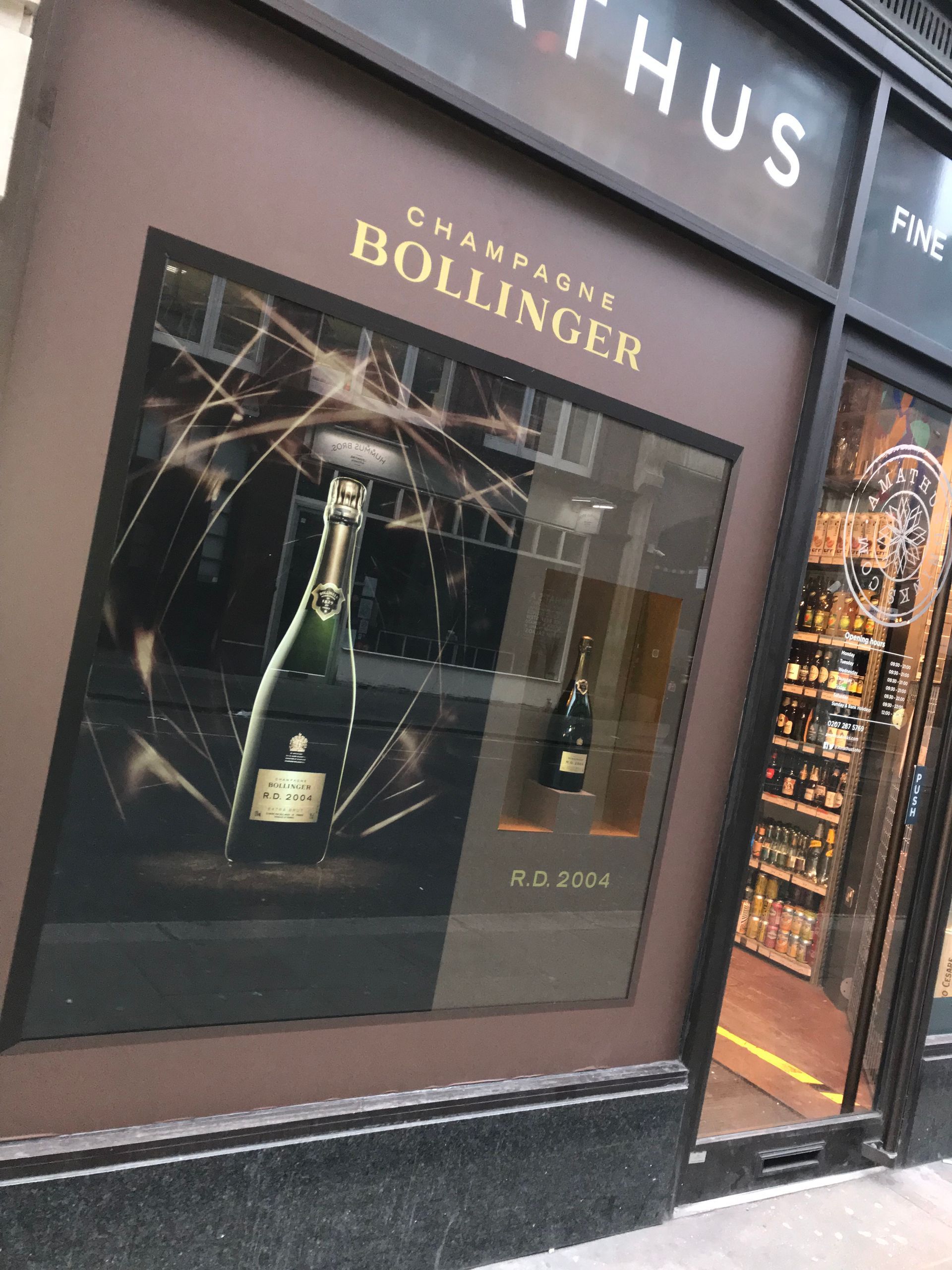 Window display for Bollinger with Gold vinyl lettering applied and large format printed panels