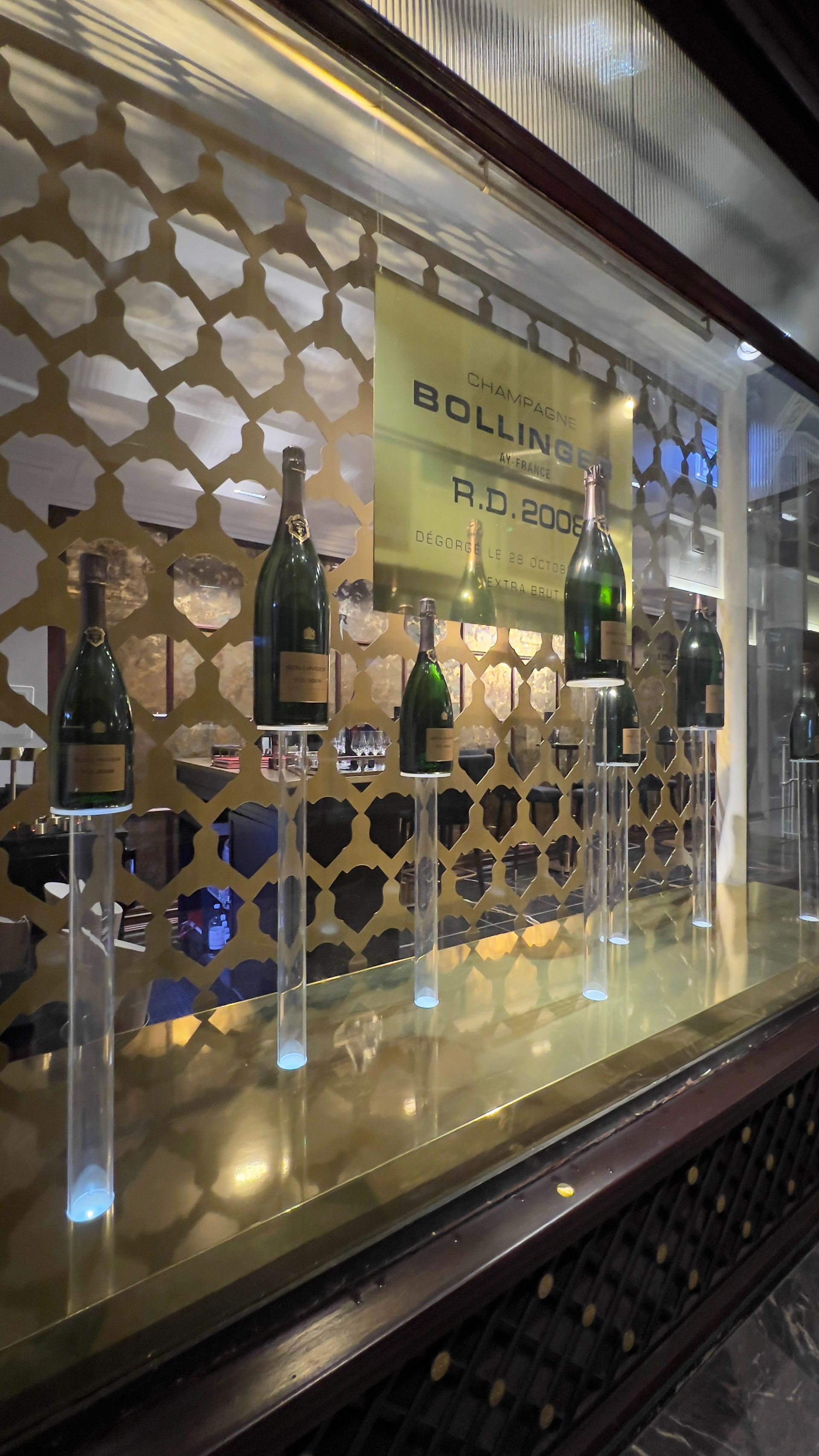 Clear Acrylic cylinder display plinths for Bollinger Champagne