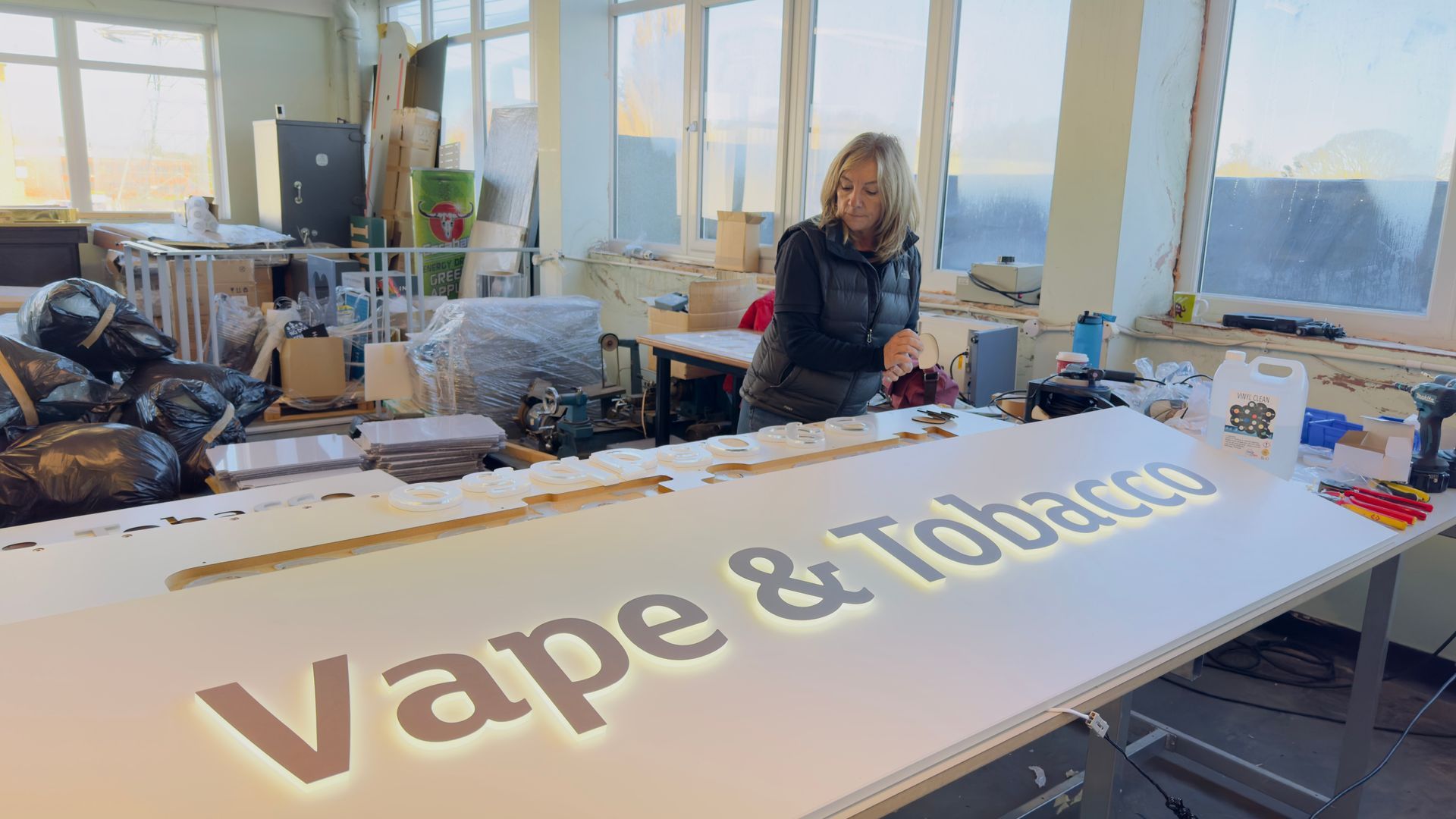 Vape & Tobacco sign constructed in CNC cut clear acrylic letters with solid colour face and LED backlit creating soft light glow around lettering