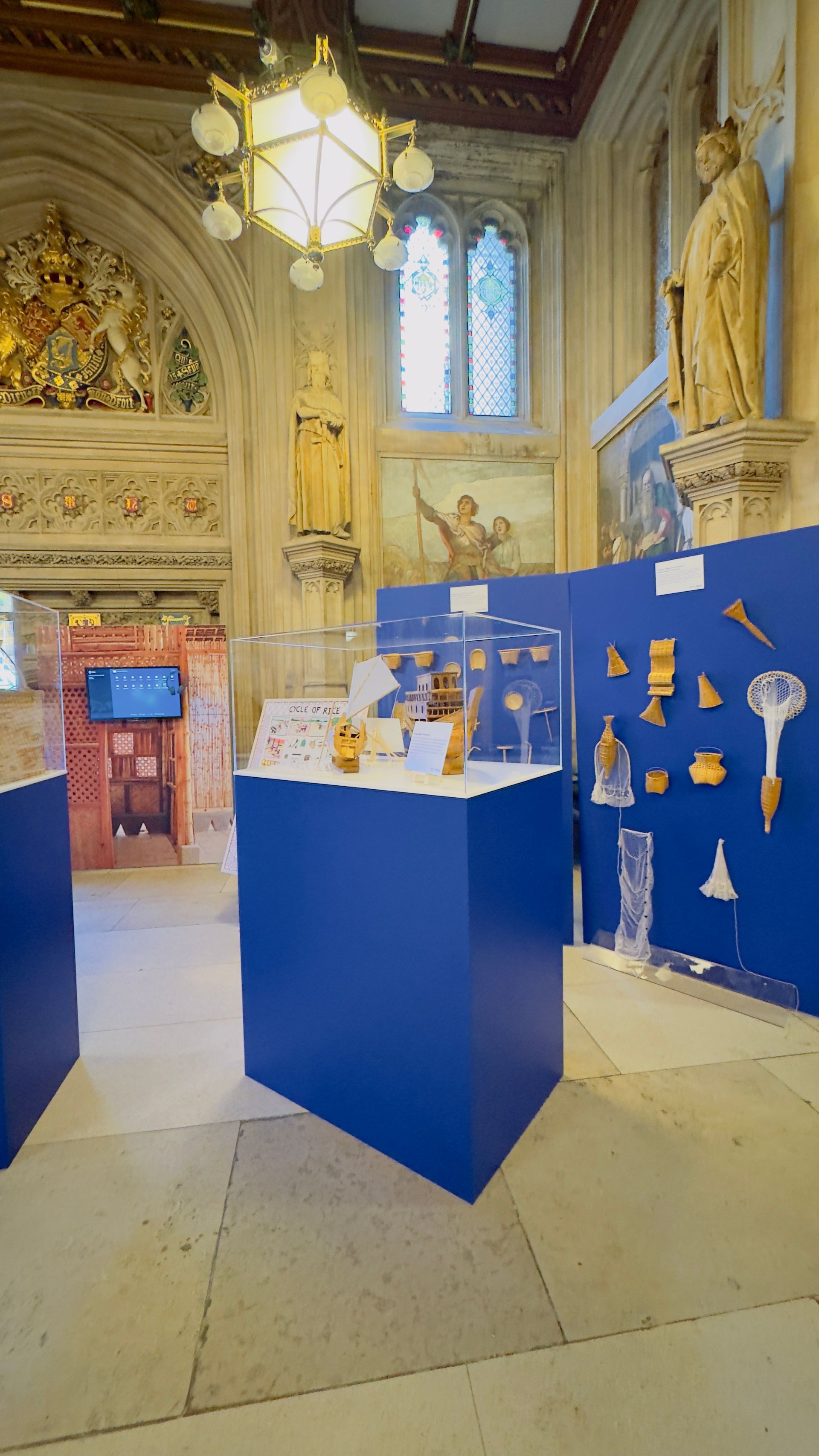 Box plinth topped with clear perspex display case containing items