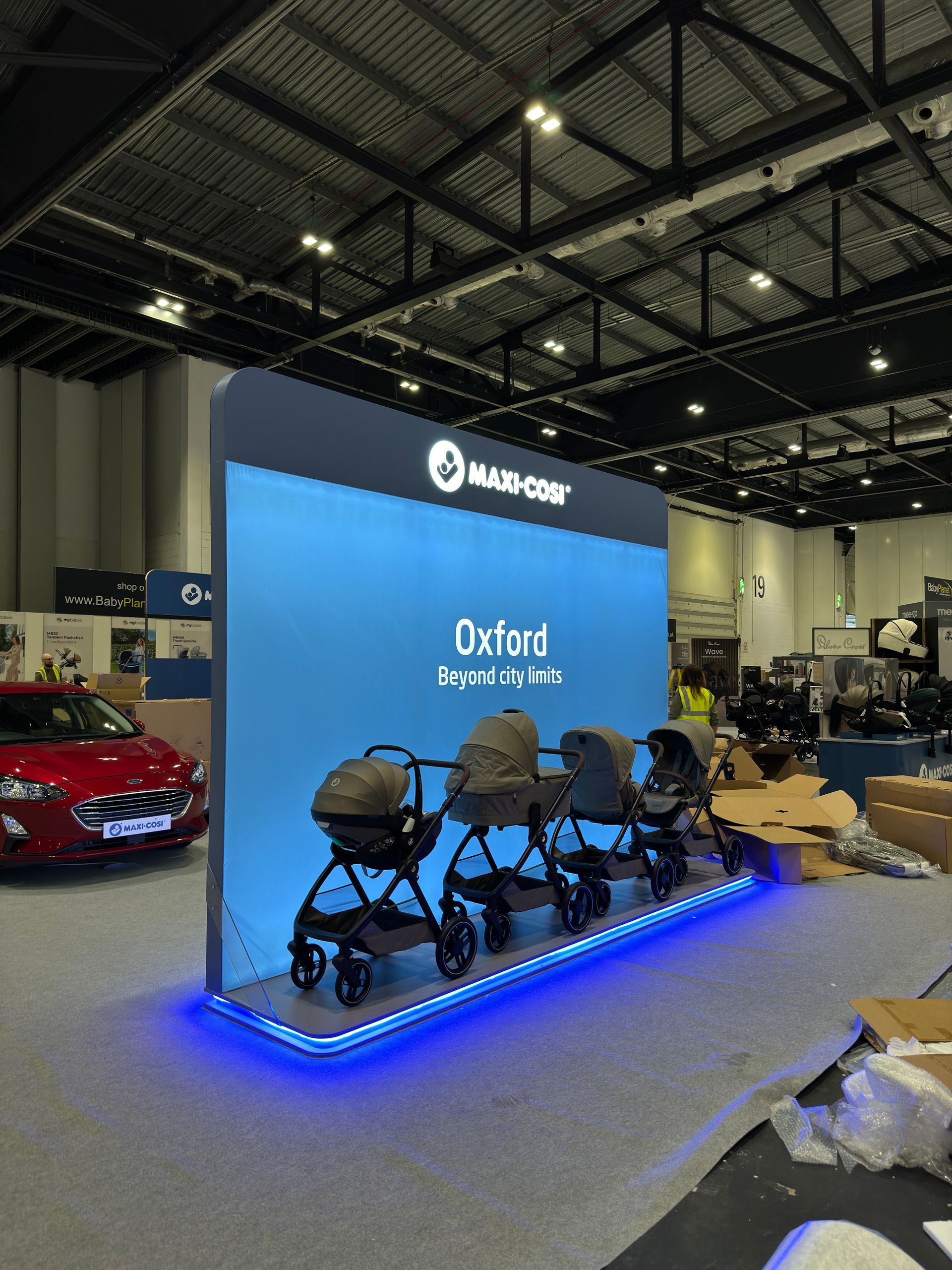 Maxi-cosi branded display with printed stretch box lit backdrop and LED floor