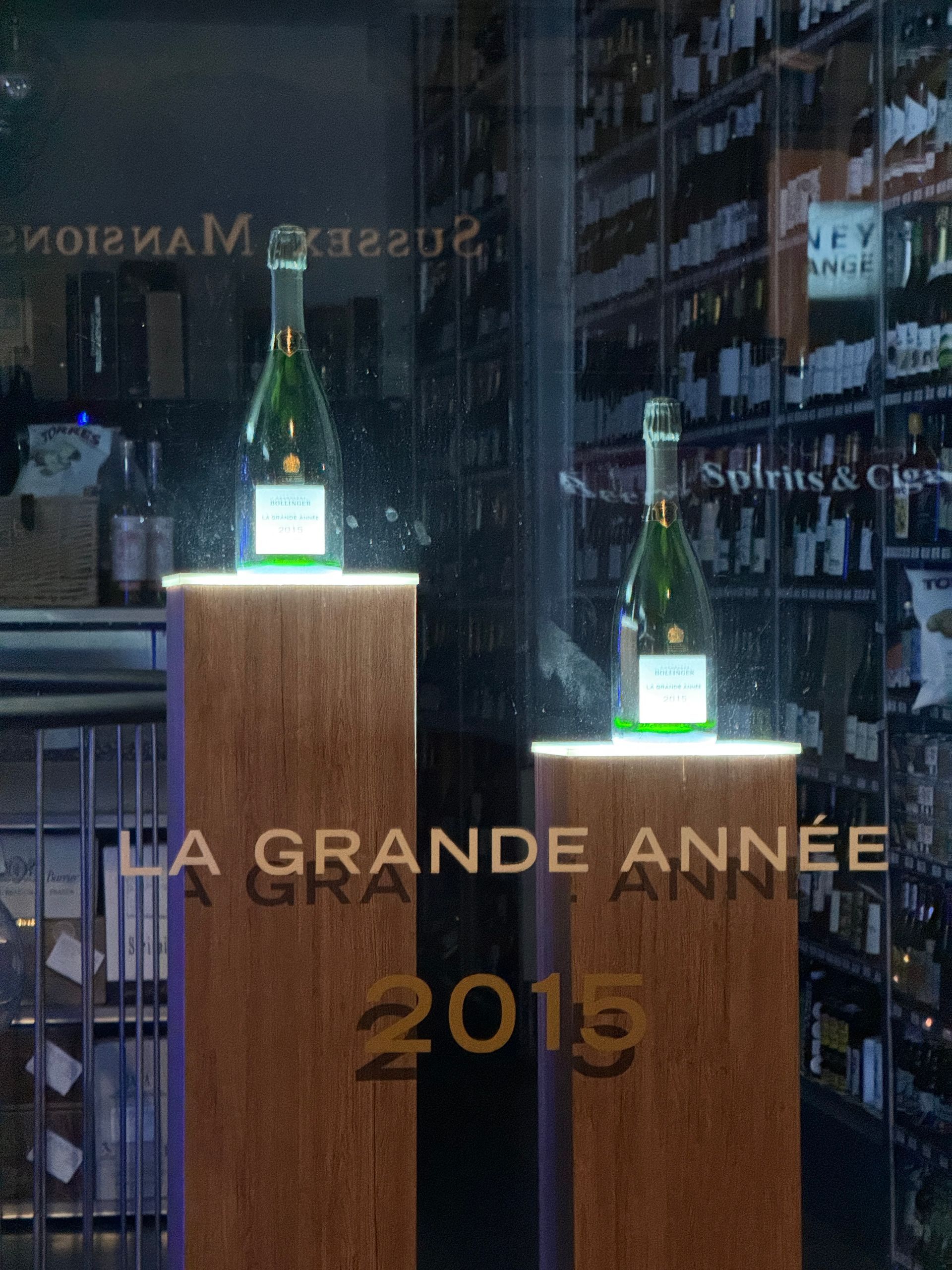 cut vinyl lettering on wine shop window 'Bollinger Grabde Annee'