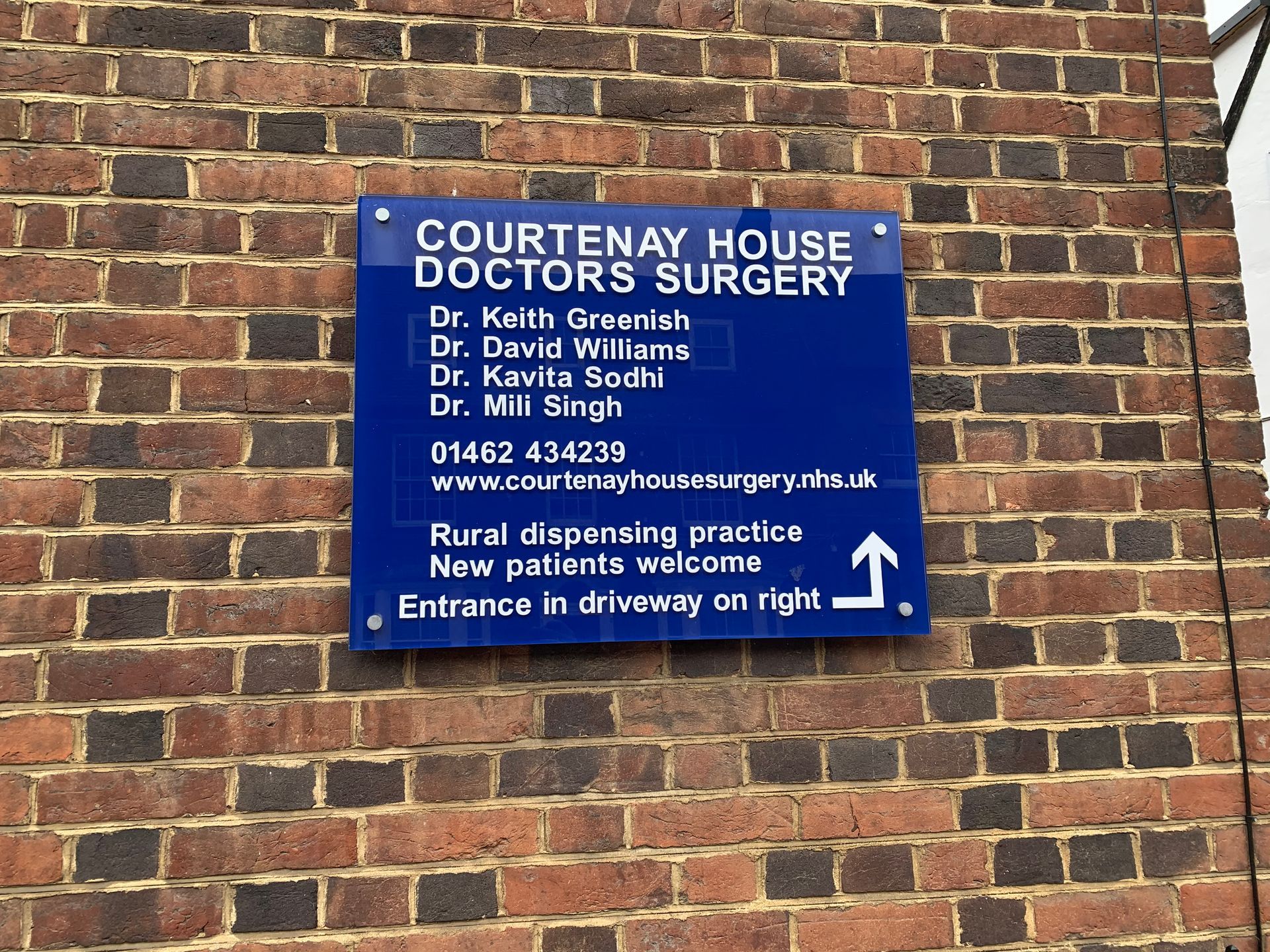Wall sign with standoff fixings mounting blue colour acrylic back with clear perspex over with cut vinyl lettering applied to face