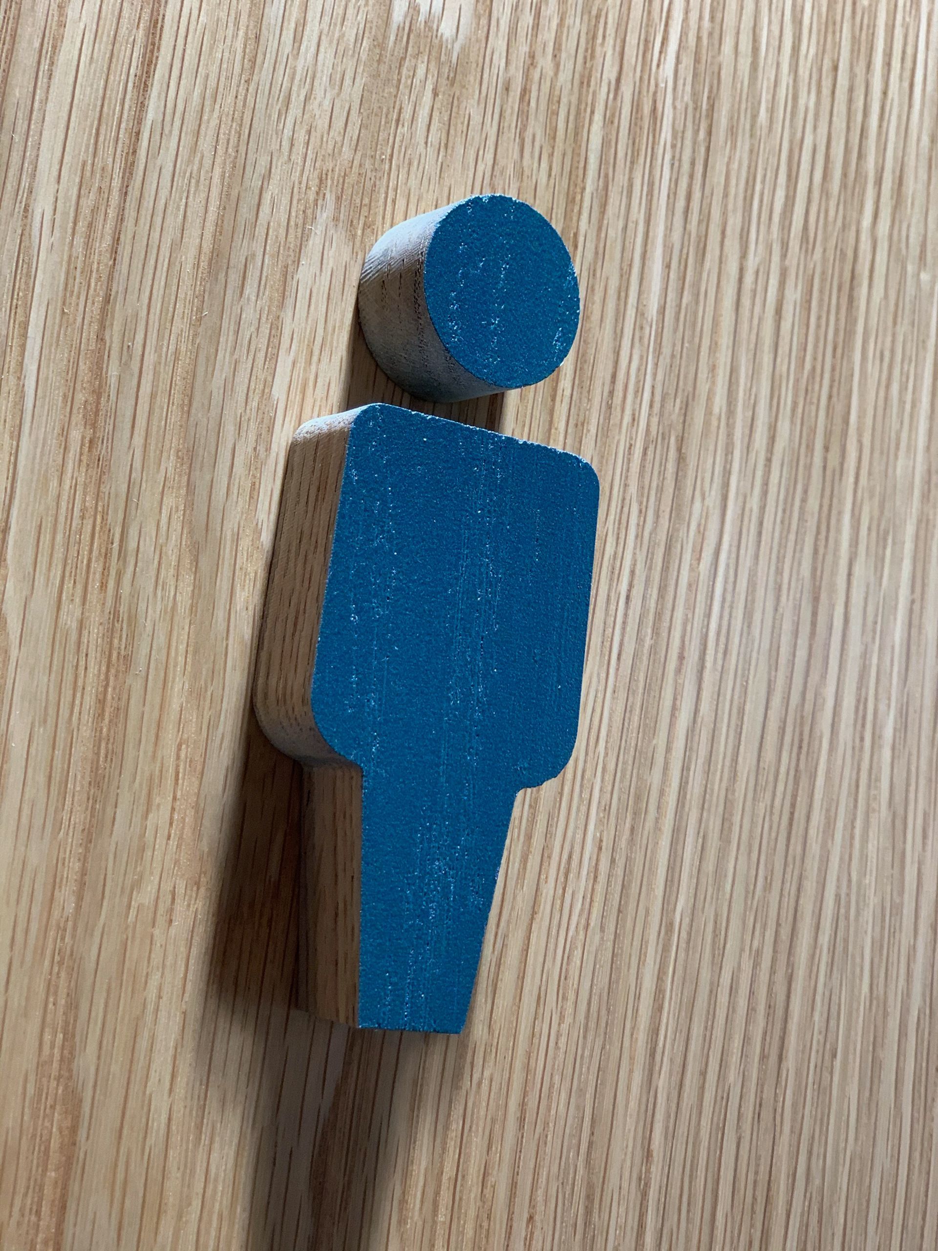 Male toilet symbol printed on wood and cut to shape