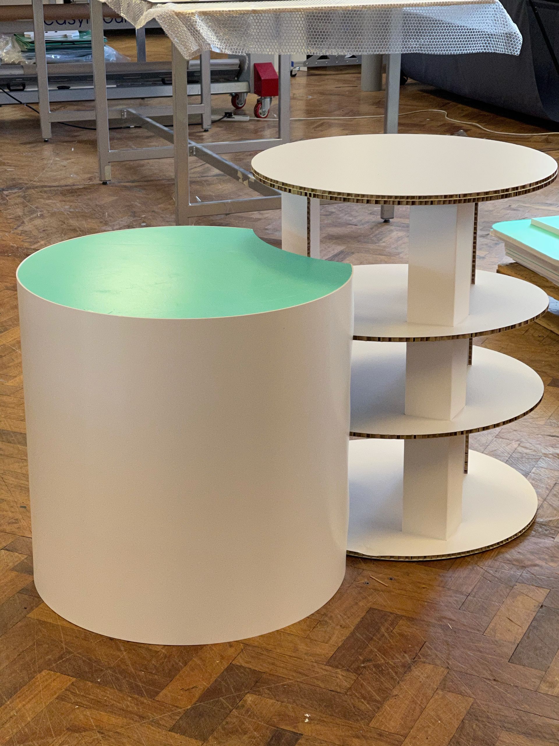 Circular Shelved table manufactured from corrugated card along with Curved foamex plinth
