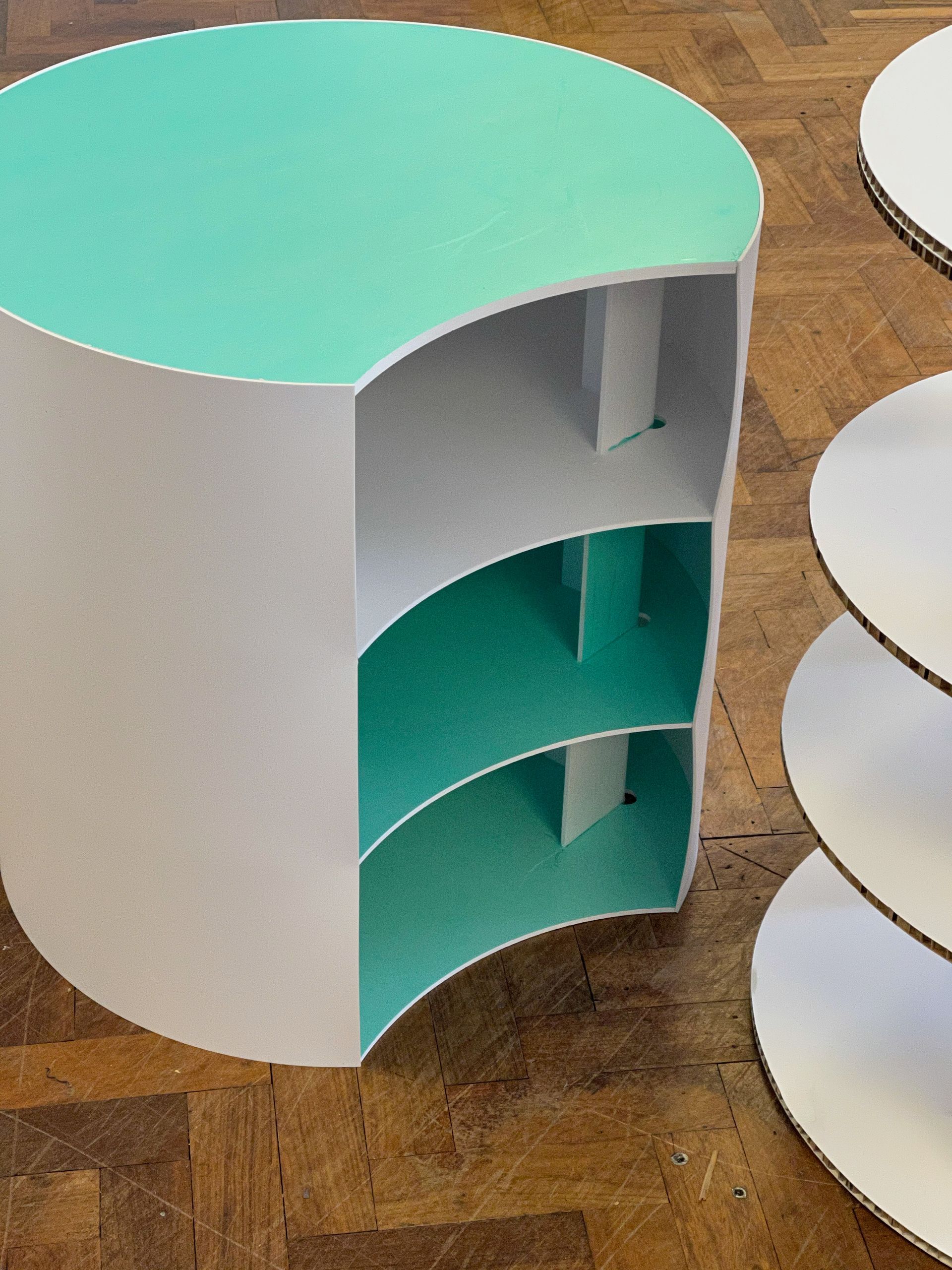 Curved plinth with shelved interior manufactured from CNC cut coloured foamex