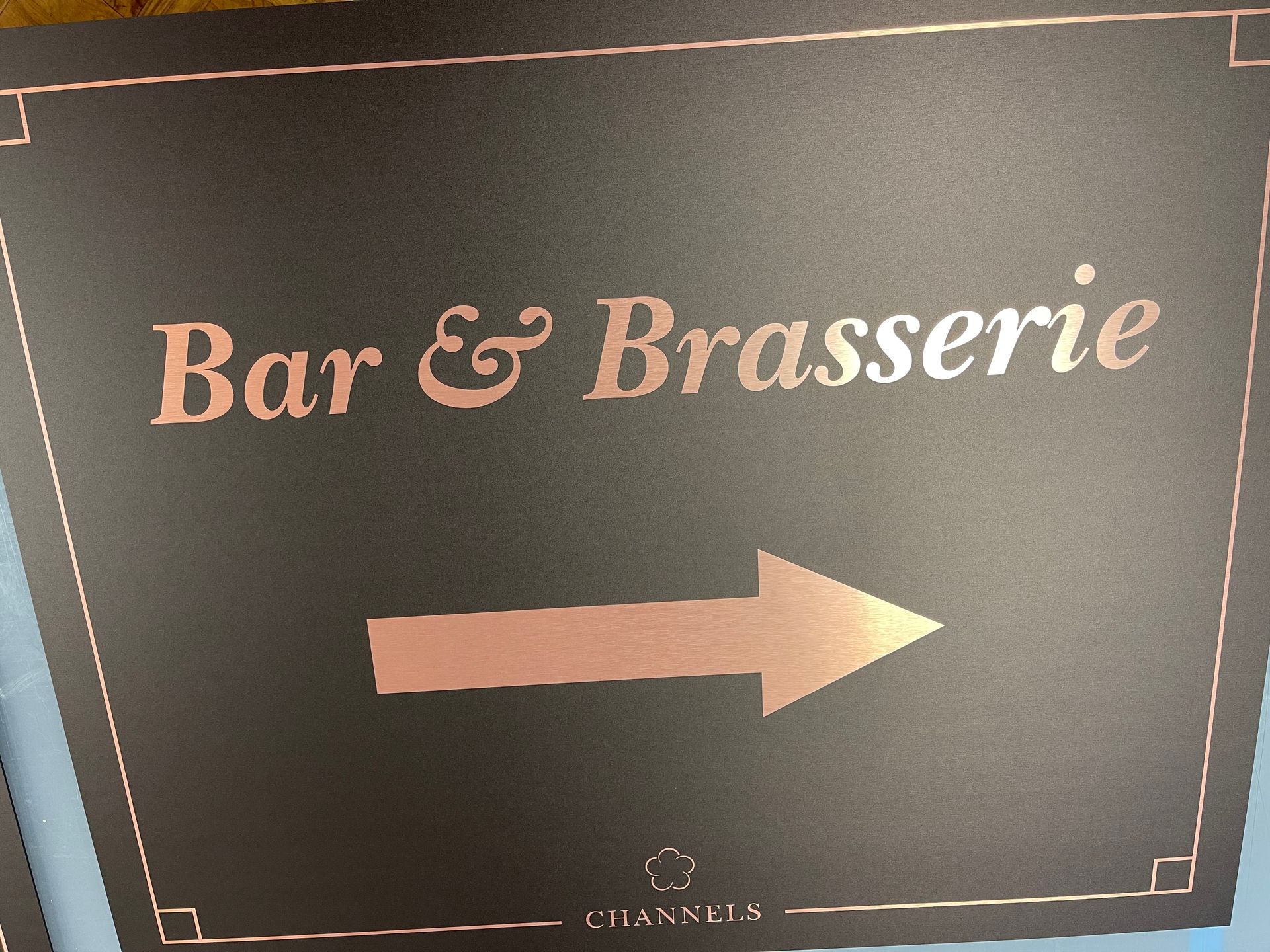 wayfinding signage 'bar & brasserie' with arrow