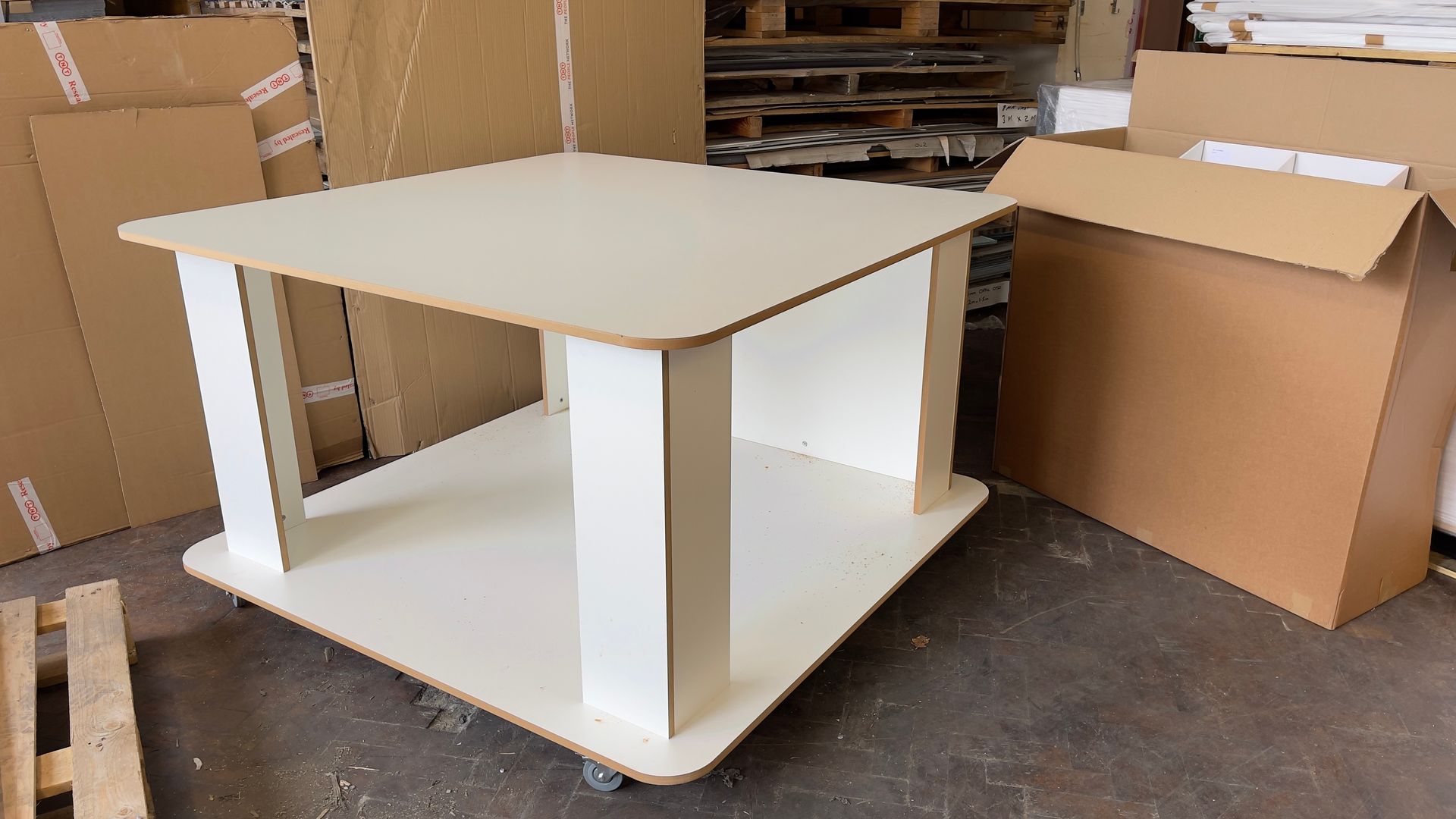 Bespoke coffee table construction from MDF heat laminated surface in white mounted with casters