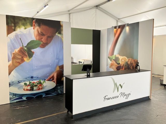 Food event Exhibition Stand Build with large printed panels showing 'Francesco Maggei' preparing his food