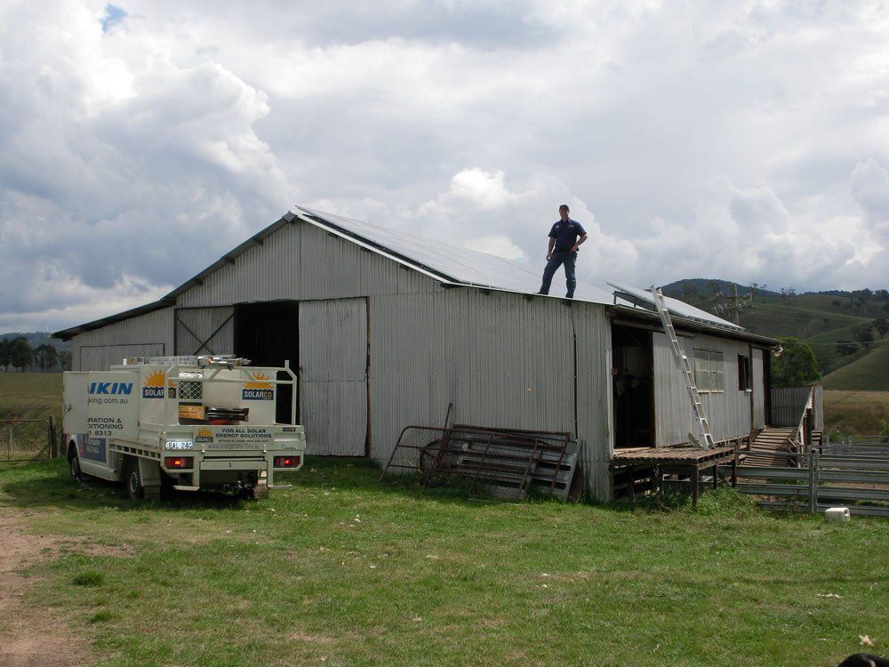 Man on the Roof Installing Solar Power System — SOLARCO Central West in Orange, NSW