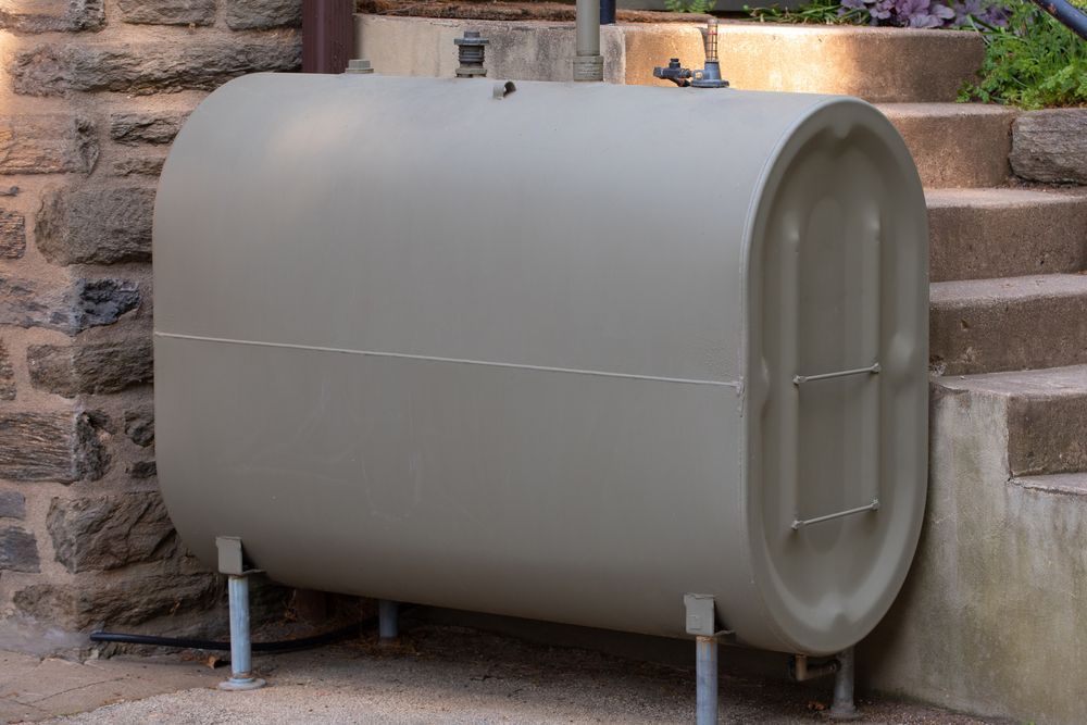 Tan Oil Tank on Metal Legs Next to Stone Steps — SOLARCO Central West in Orange, NSW