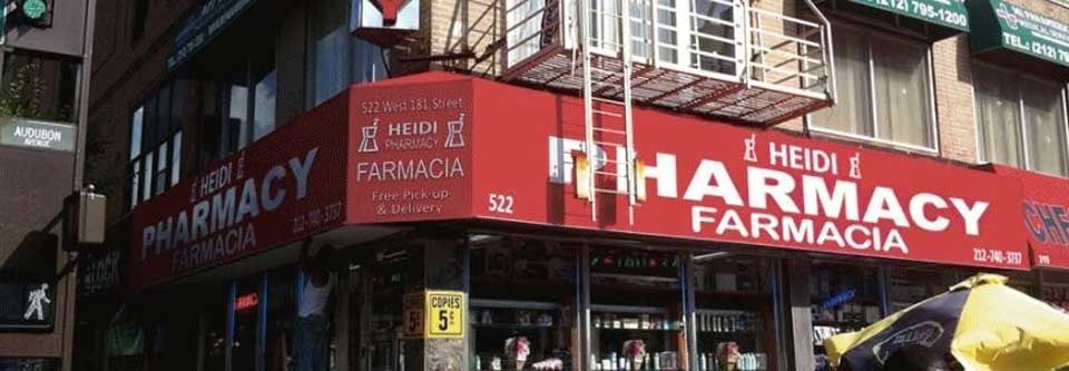 Storefront with a red pharmacy sign reading “PHARMACY / FARMACIA” and “MEDI.”