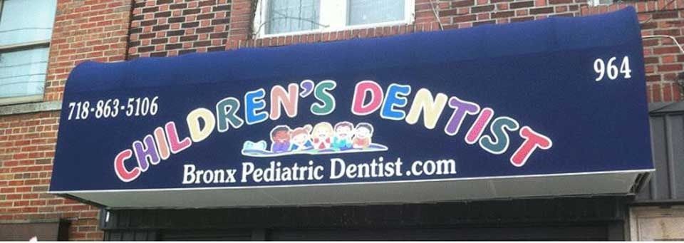 Blue awning for Bronx Pediatric Dentist with phone number and address 964 on a brick building