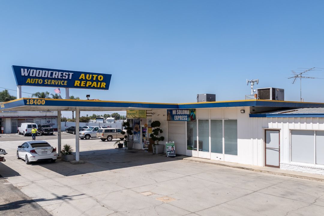 Winkler’s Auto body and auto repair shop with parked cars under a blue sky