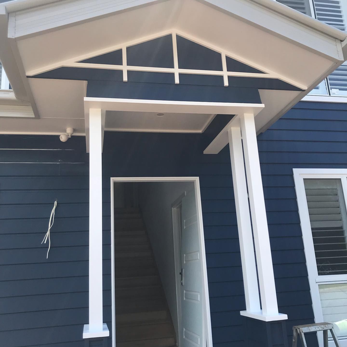 A Blue House With A White Porch And Stairs — Ballina Painting Service In Ballina, NSW