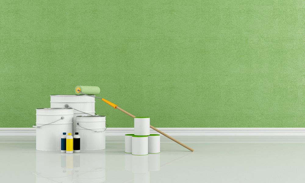 A Room With A Green Wall And Buckets Of Paint And A Paint Roller — Ballina Painting Service In Ballina, NSW