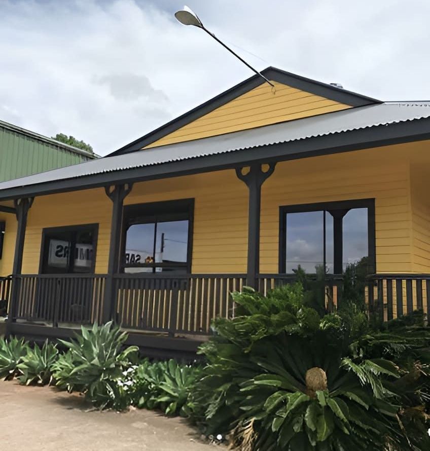 A Yellow House With A Porch Has The Number 212 On The Front — Ballina Painting Service In Ballina, NSW