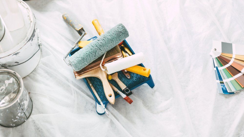 A Bunch Of Paint Rollers And Brushes On A Table — Ballina Painting Service In Bangalow, NSW