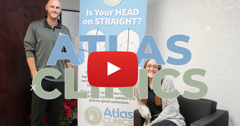 Two people in front of a banner for Atlas Clinics, a man standing and a woman seated. Text overlay says