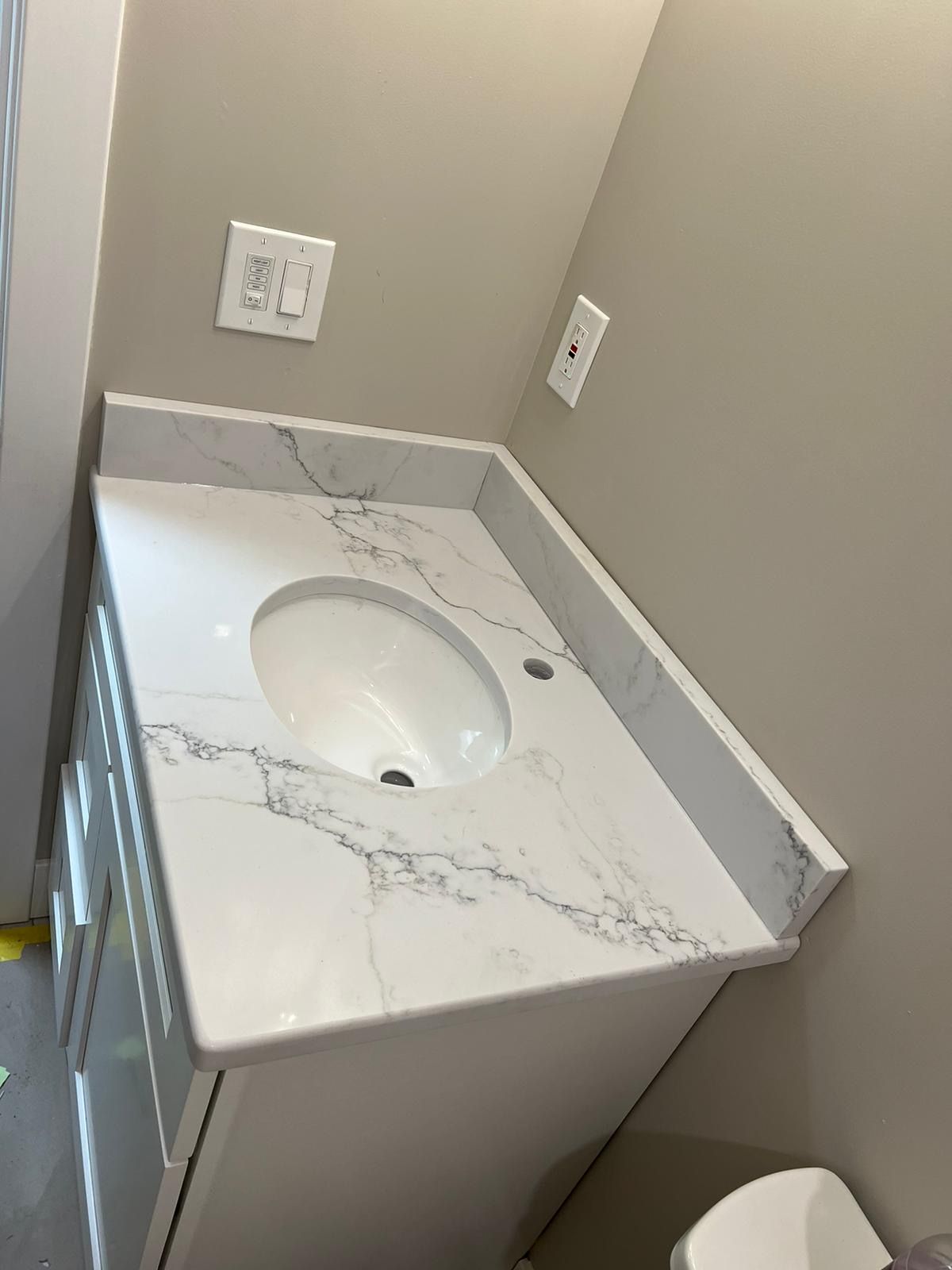 A bathroom with a sink and a toilet.