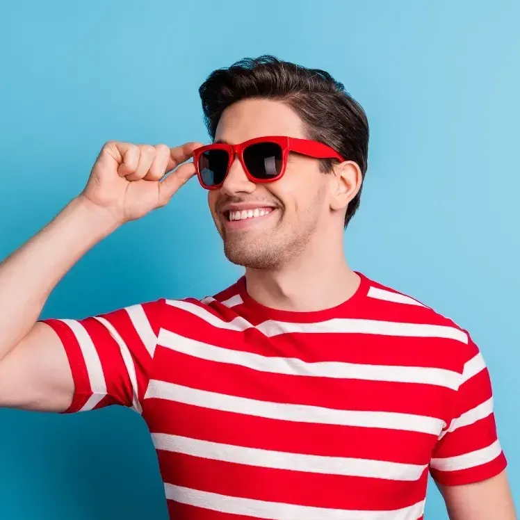 Guy with red sunglasses and striped shirt, smiling