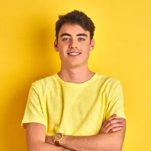 teenage boy with invisalign, yellow background