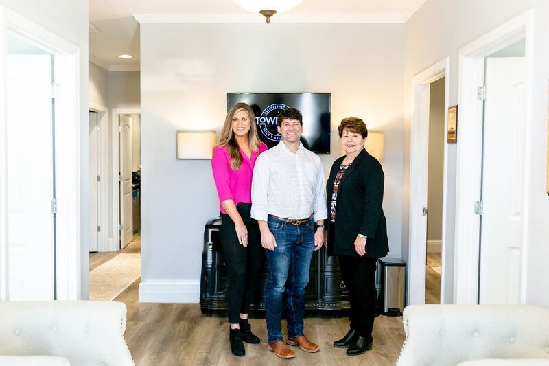 A group of people are standing next to each other in a room.