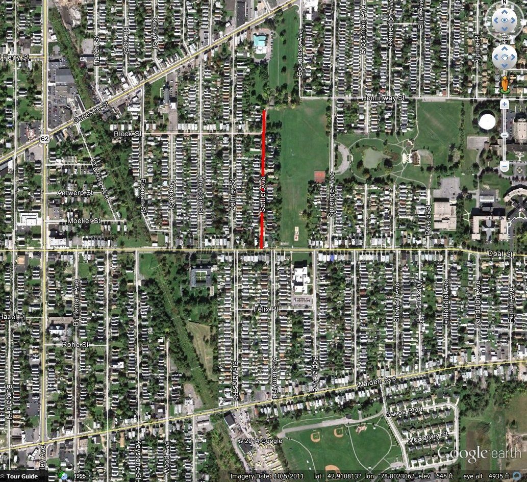 An overhead satellite view of a suburban neighborhood with a prominent red line marking a specific street section.